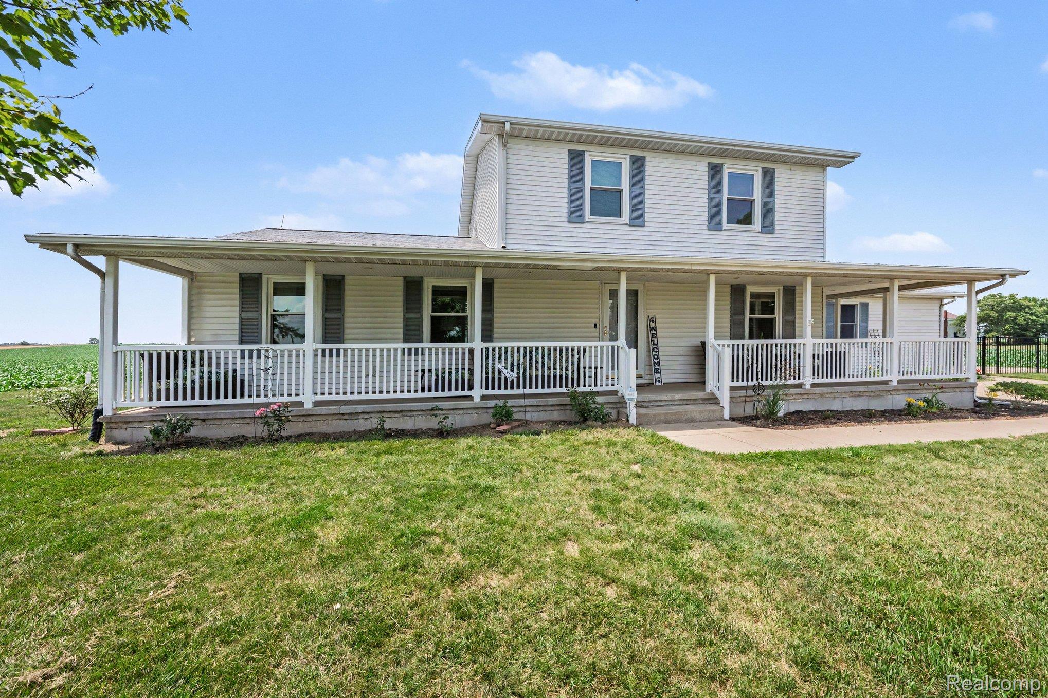 996 Arbogast Road Union City, MI 49094 - Photo 2 of 34 Two-story residence featuring white vinyl siding and a full-length covered porch with white railings