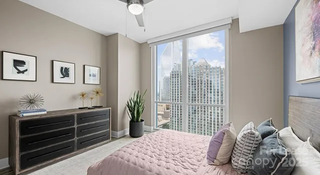 a bedroom with a bed and a large window