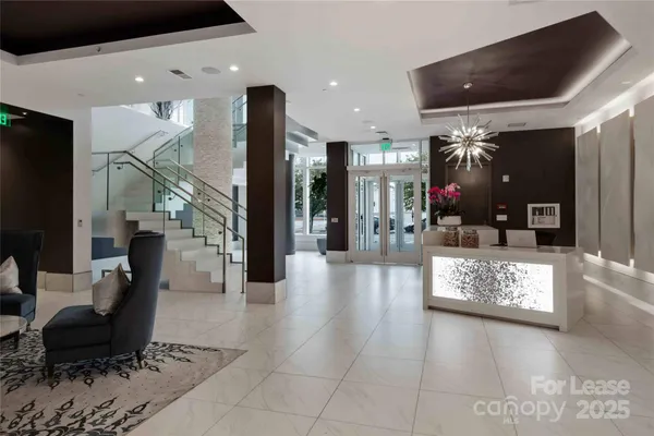 a lobby with furniture and a chandelier