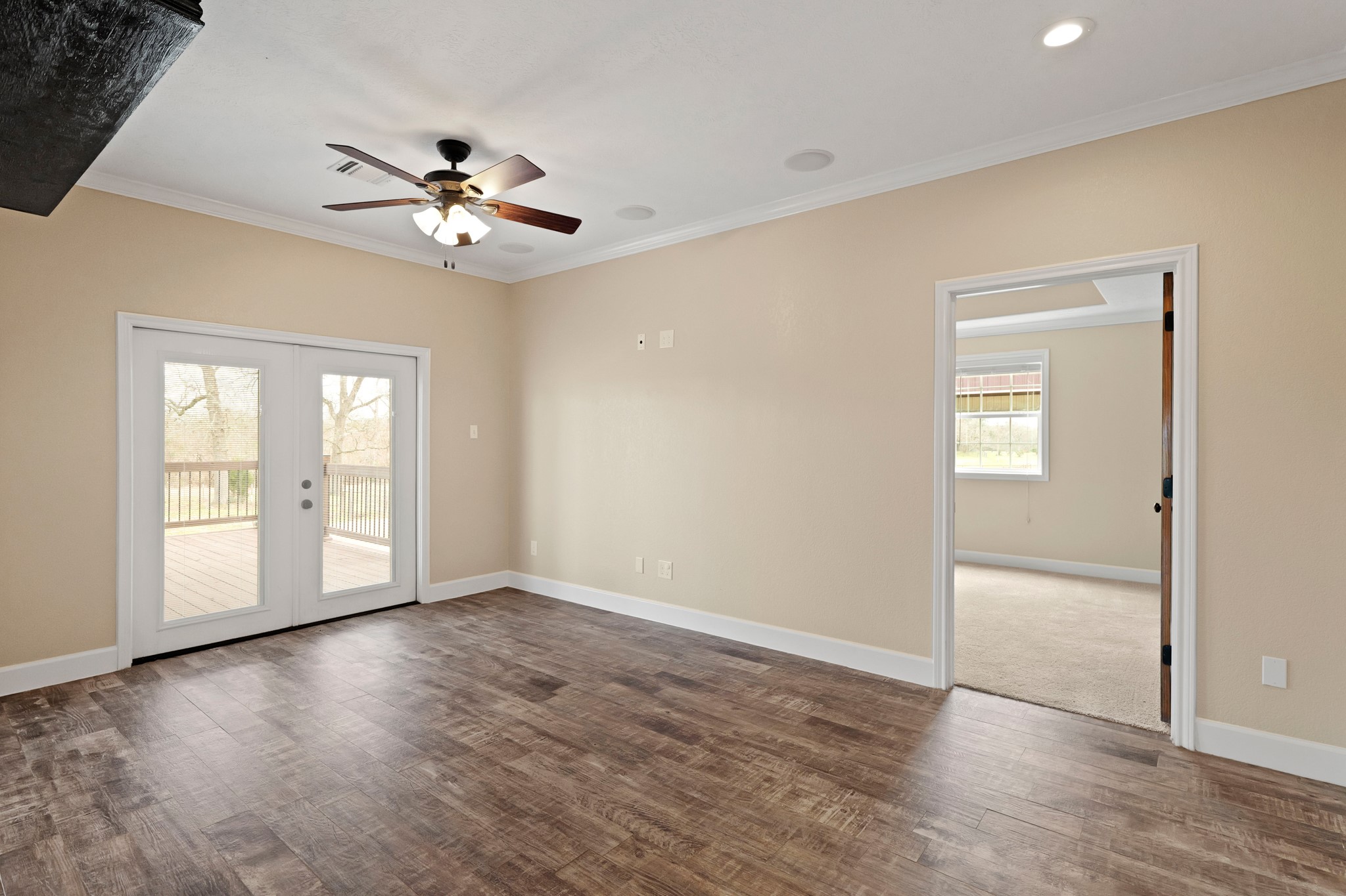 35408 Farm To Market Road 1488 Hempstead, TX 77445 - Photo 16 of 50 an empty room with wooden floor chandelier fan and windows