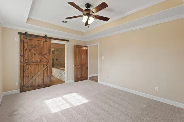 a view of a livingroom with a ceiling fan and window