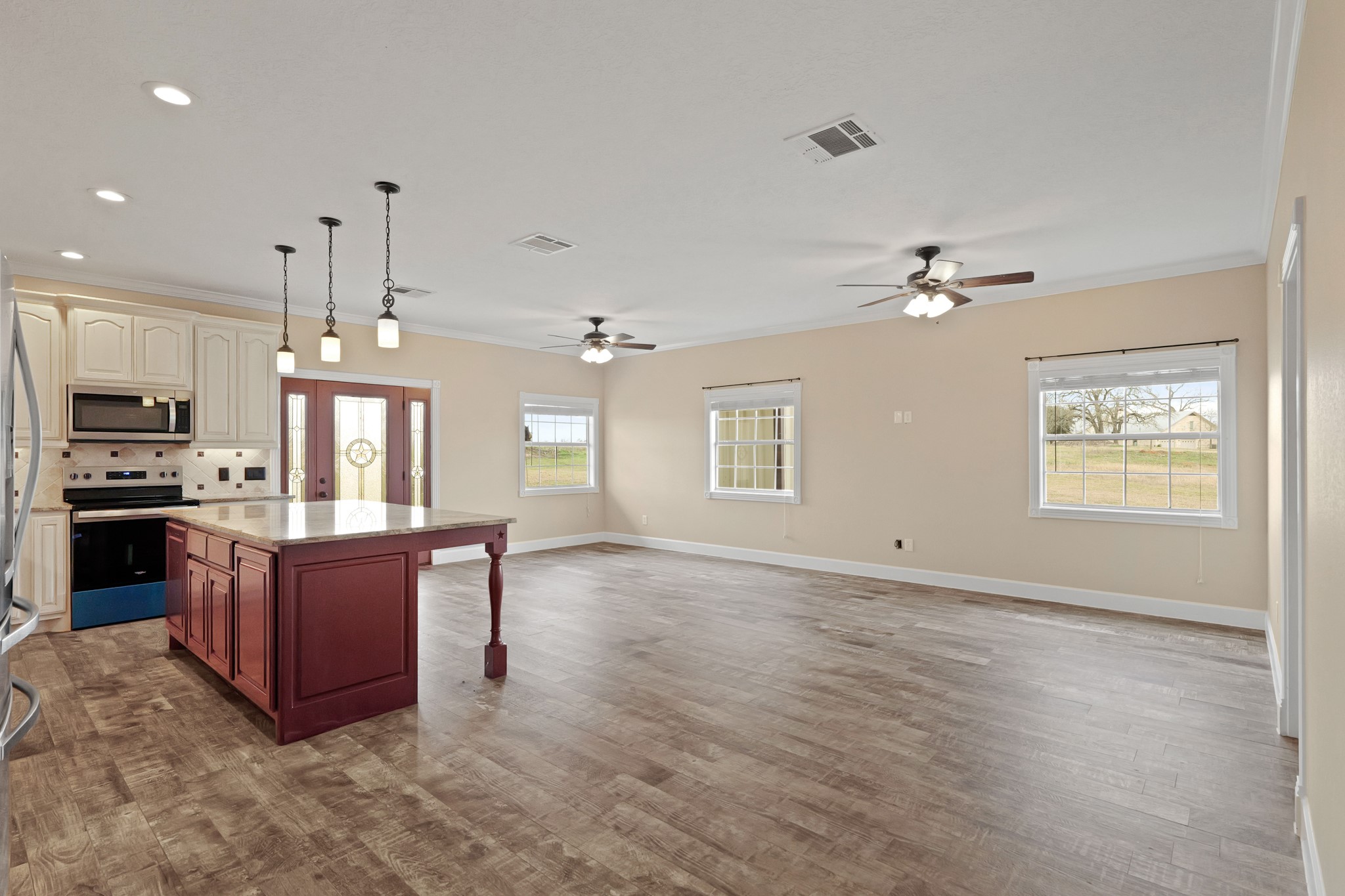 35408 Farm To Market Road 1488 Hempstead, TX 77445 - Photo 6 of 50 a living room with couches and kitchen view with wooden floor