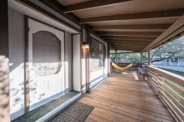 a view of a balcony with wooden floor