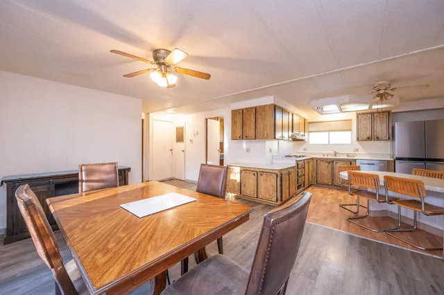 a dining room with a table chairs and a kitchen view
