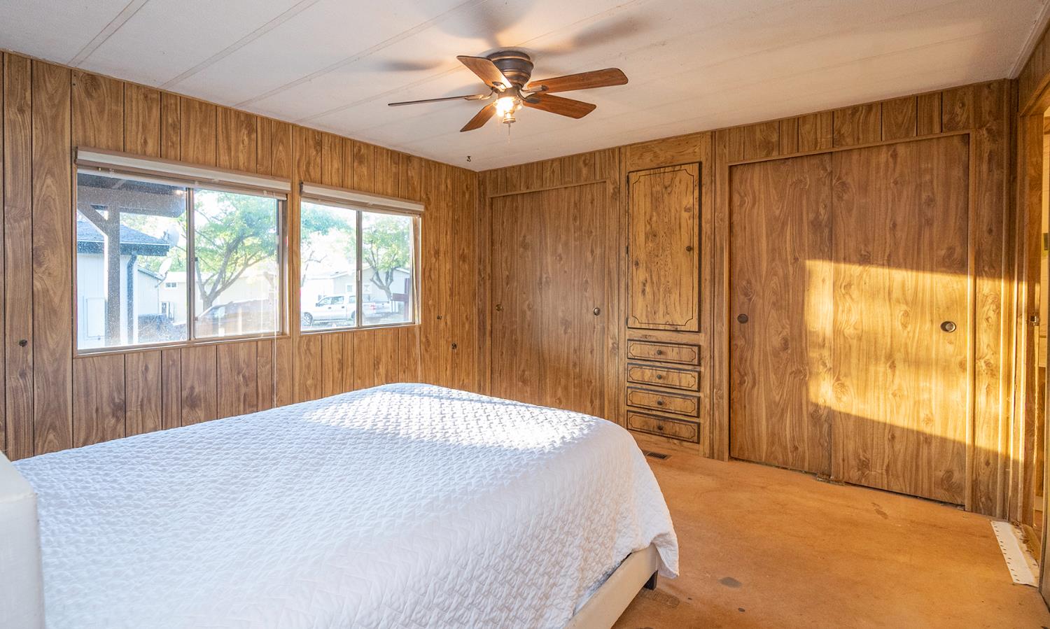 2000 Camanche Road, Unit 234 Ione, CA 95640 - Photo 31 of 41 a bedroom with a large bed and a chandelier fan