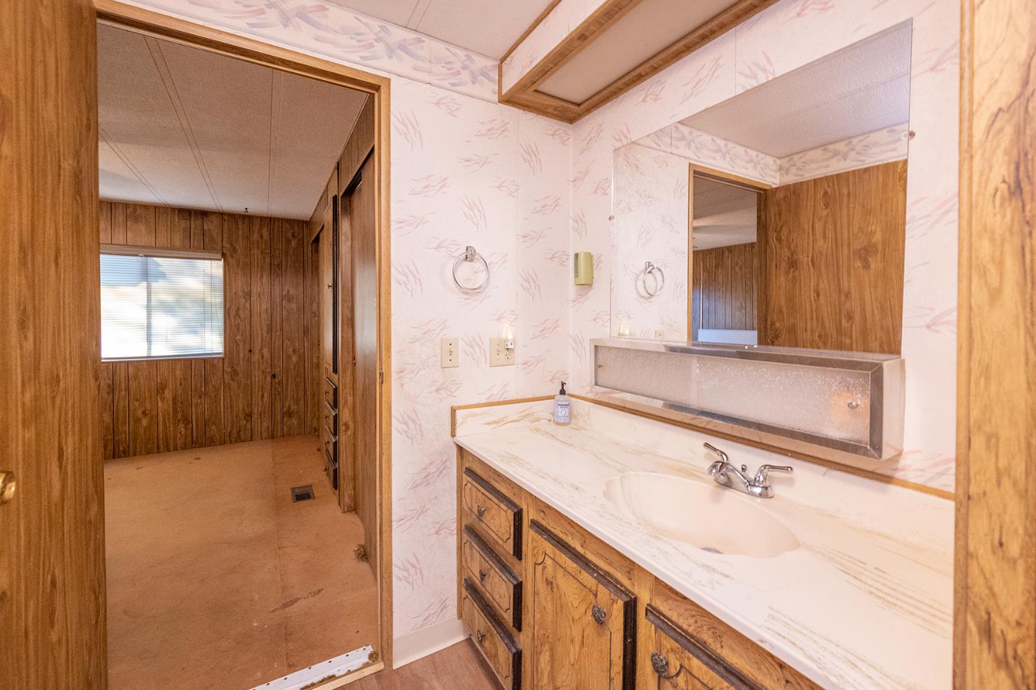 2000 Camanche Road, Unit 234 Ione, CA 95640 - Photo 35 of 41 a bathroom with a sink a vanity and a mirror