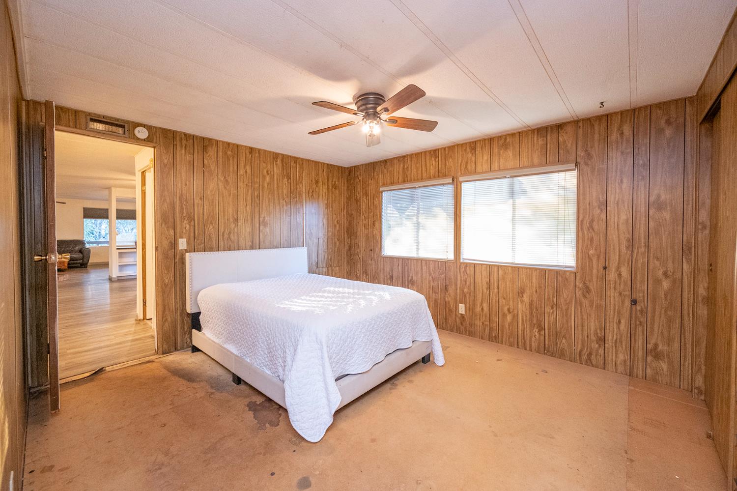 2000 Camanche Road, Unit 234 Ione, CA 95640 - Photo 36 of 41 a bedroom with a bed and a chandelier