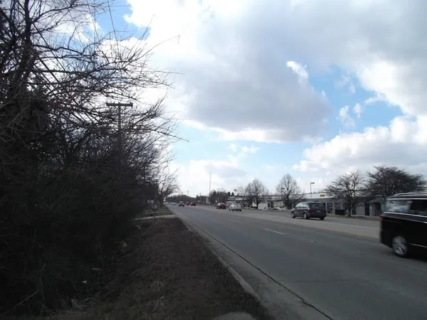 a view of street with parked cars