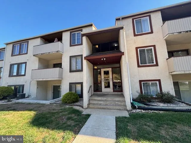 a front view of a house with yard and furniture