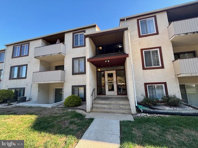 a front view of a house with yard and furniture