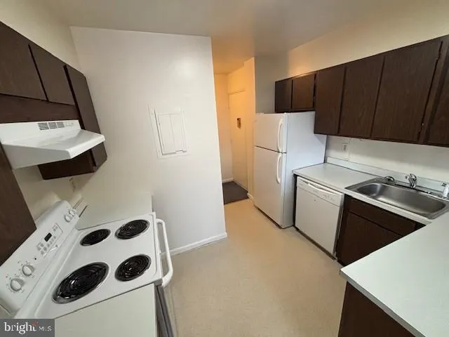 a kitchen with a refrigerator and a stove