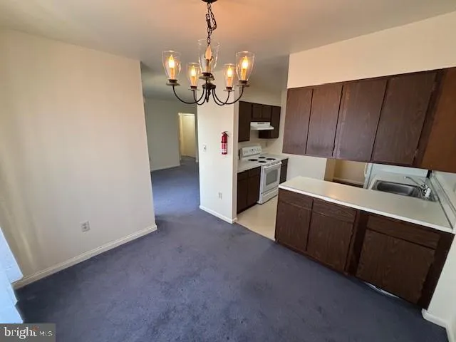 a kitchen that has a sink stainless steel appliances a counter space and cabinets