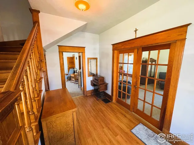 a living room with a couch and wooden floor