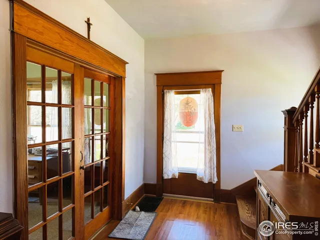 a view of a room with wooden floor and a window