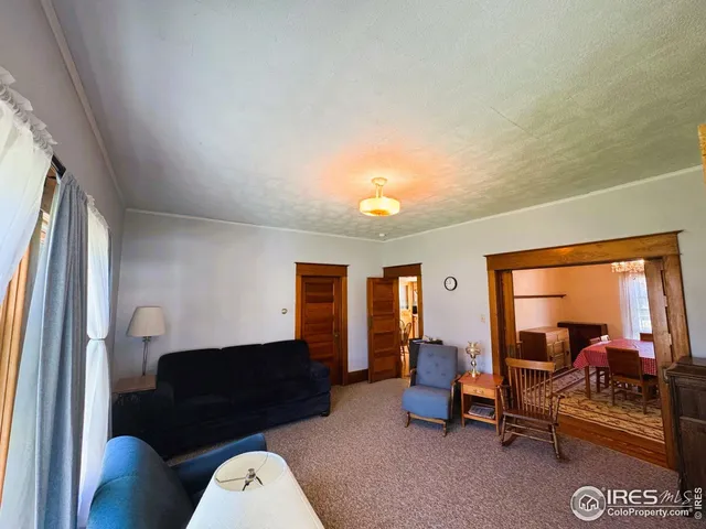 a living room with furniture and a mirror