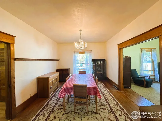 a living room with furniture rug and a table
