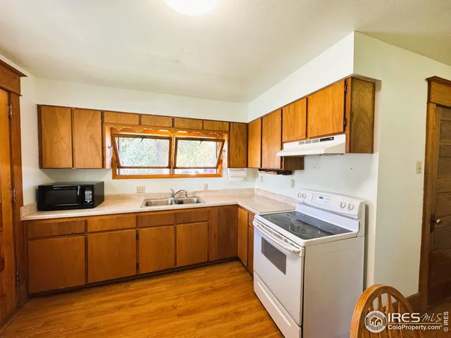 a kitchen with a sink stove and cabinets