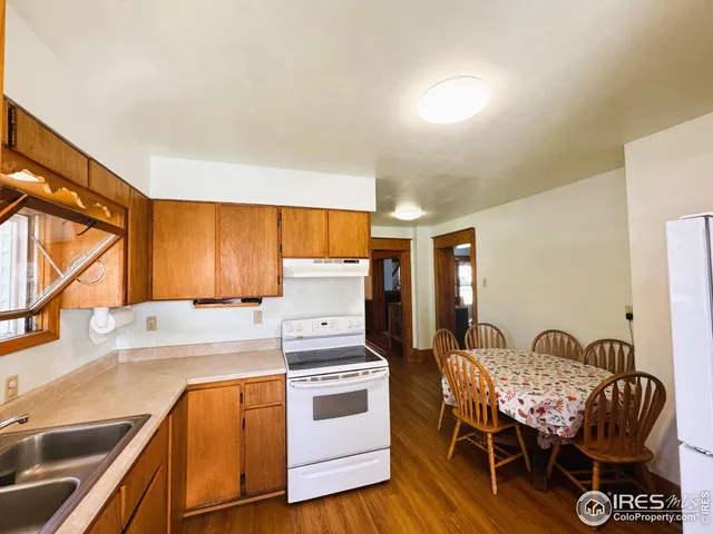 a kitchen with a table chairs and a stove