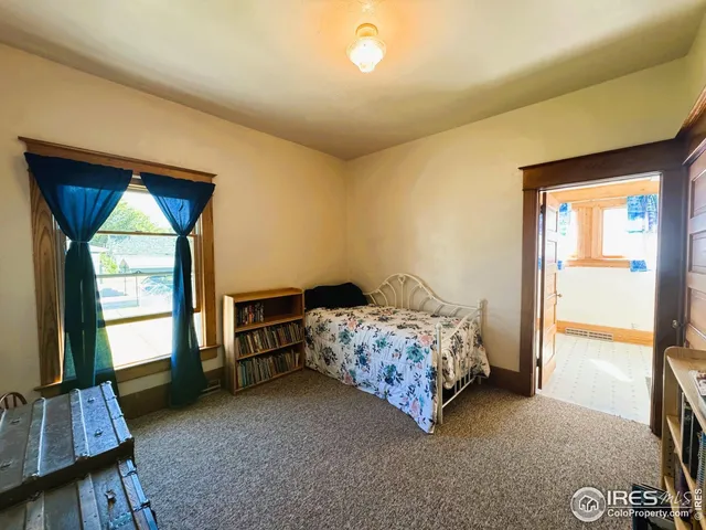 a bedroom with bed and a window