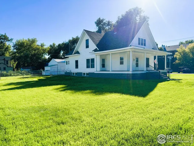 a front view of a house with swimming pool and porch
