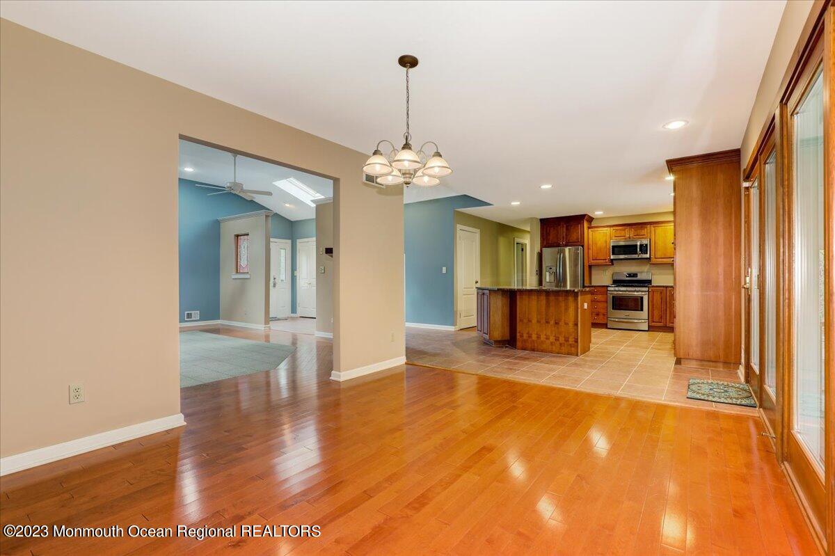 56 Wyckham Road Tinton Falls, NJ 07724 - Photo 18 of 40 a view of a living room and kitchen with stainless steel appliances