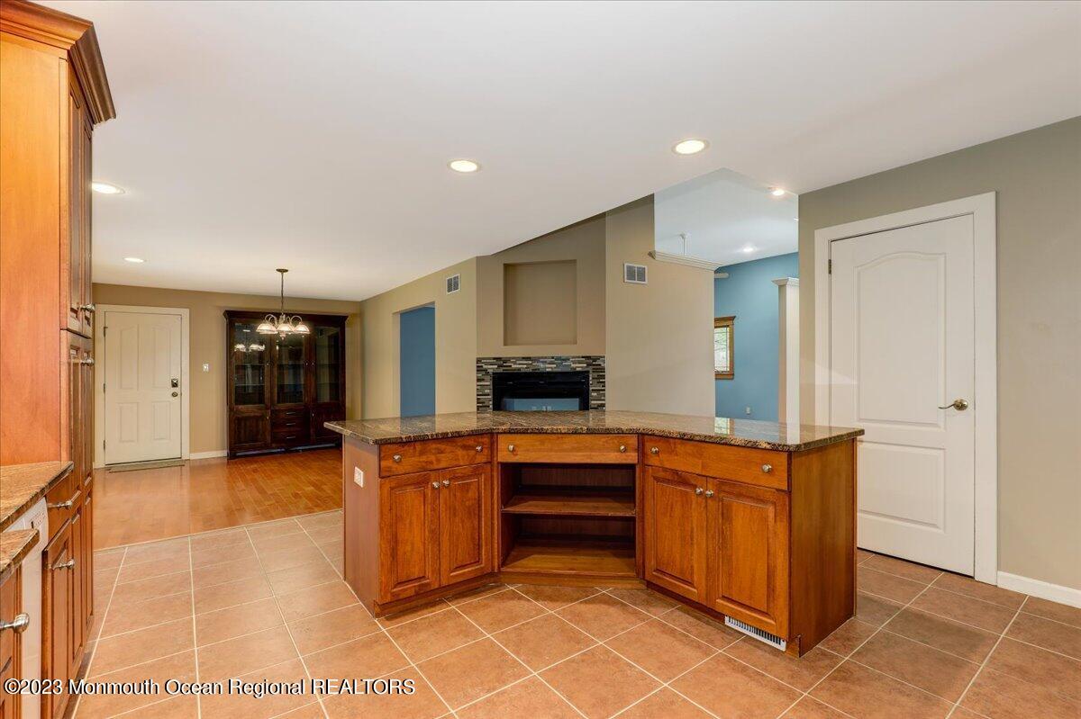 56 Wyckham Road Tinton Falls, NJ 07724 - Photo 23 of 40 a kitchen with stainless steel appliances granite countertop a refrigerator and a stove top oven
