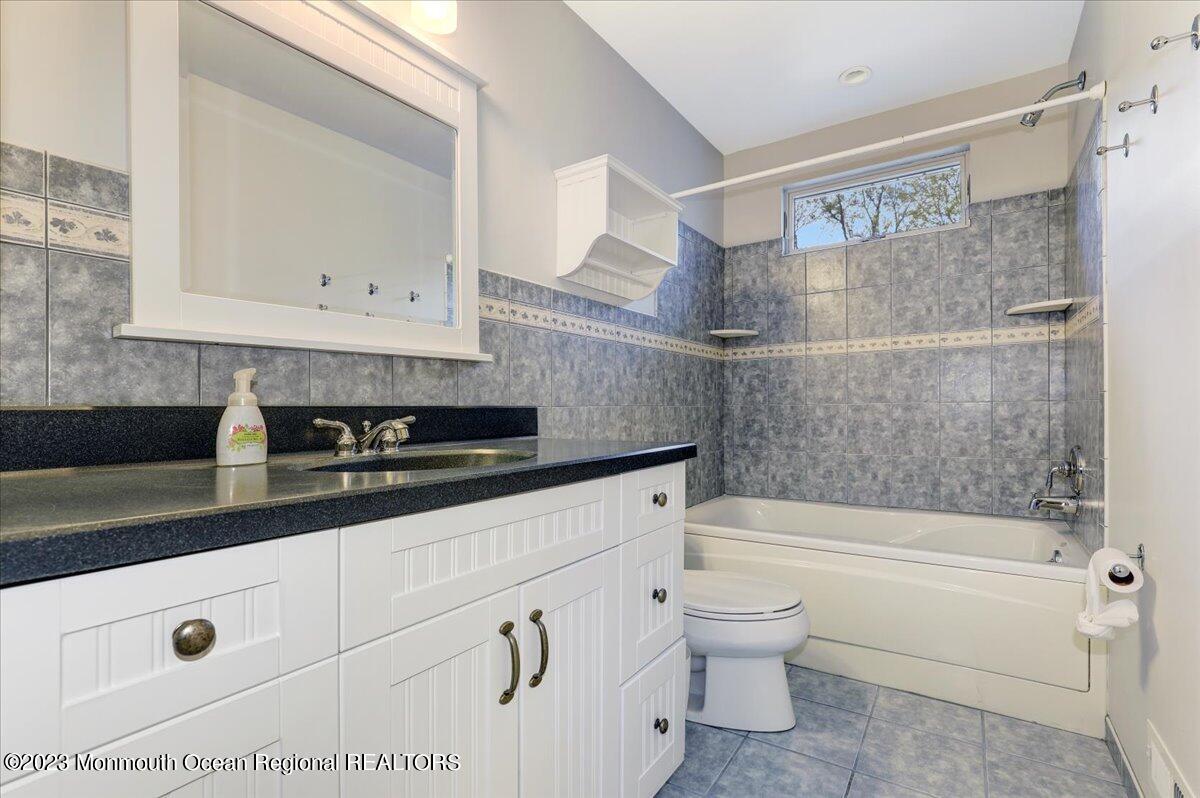 56 Wyckham Road Tinton Falls, NJ 07724 - Photo 37 of 40 a bathroom with a bathtub shower sink and toilet