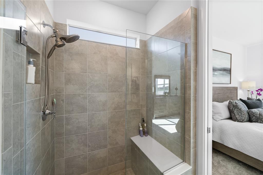 10646 Spring Tide Way Palmetto, FL 34221 - Photo 17 of 35 Frameless glass shower surround and with a practical BENCH and product niche