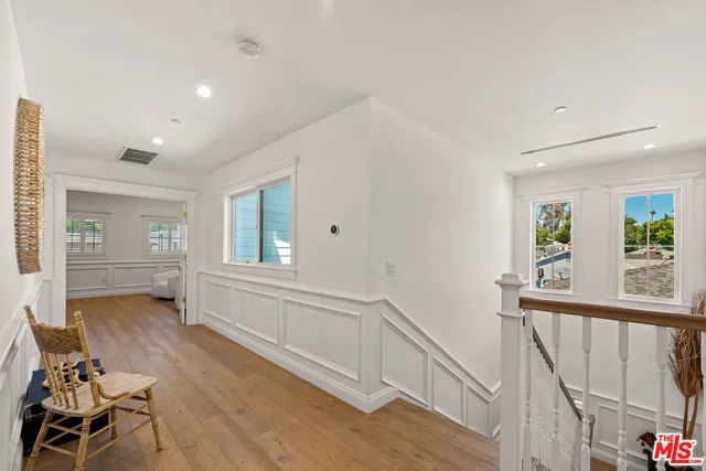 a view of livingroom with furniture staircase and windows