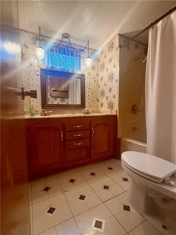 a bathroom with a glass door shower and a sink
