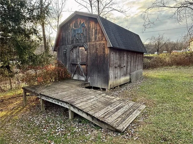a wooden fence with a bench in the background