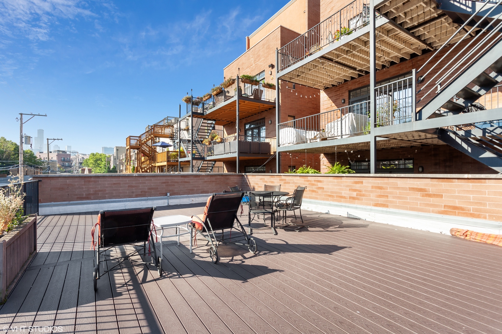 1363 North Mohawk Street, Unit 1 Chicago, IL 60610 - Photo 4 of 14 a view of a rooftop deck with couch and chairs
