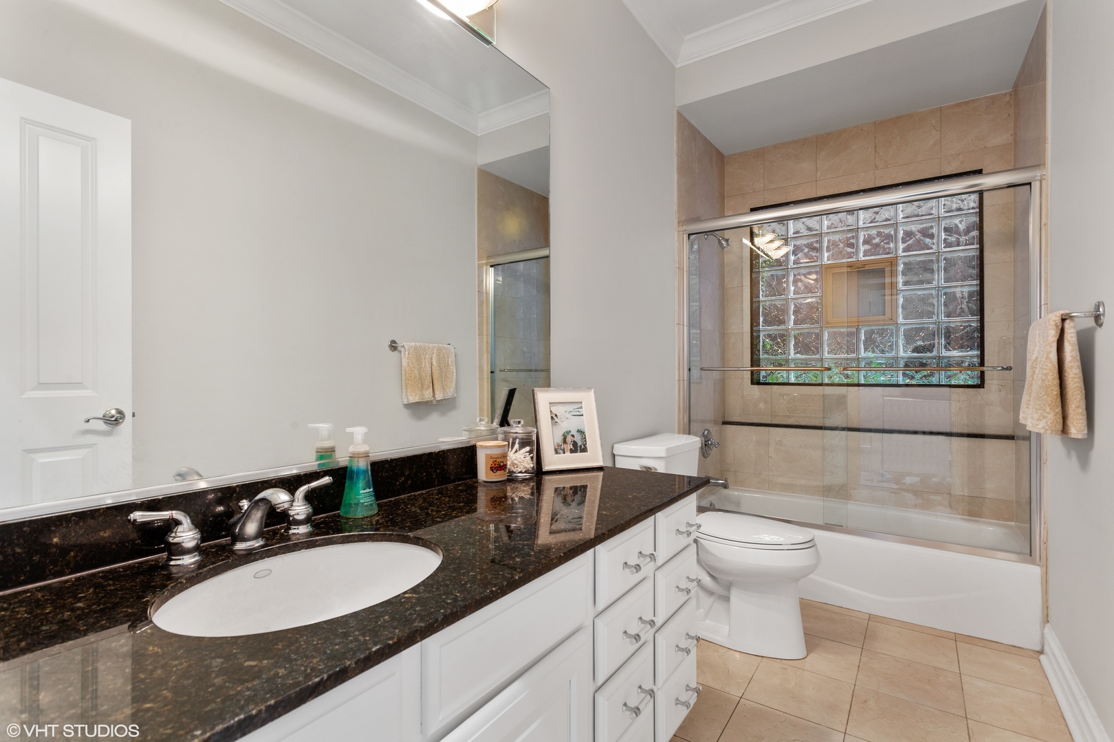 1363 North Mohawk Street, Unit 1 Chicago, IL 60610 - Photo 9 of 14 a bathroom with a granite countertop sink toilet and mirror