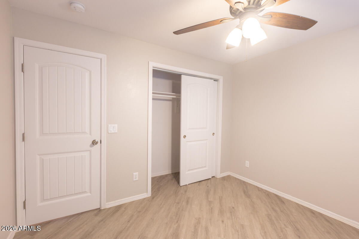 24638 East Bartlett Road Florence, AZ 85132 - Photo 16 of 21 an empty room with wooden floor closet and fan