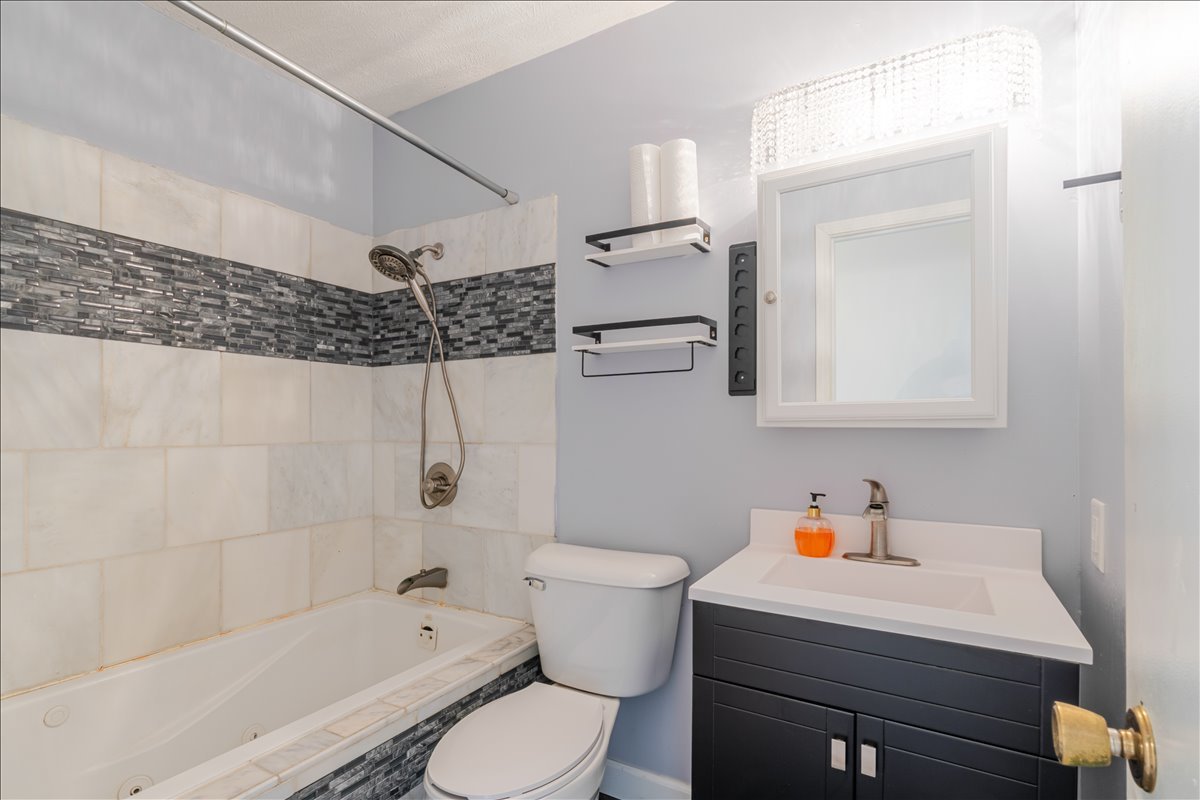 103 South Towanda Avenue, Unit 3 Normal, IL 61761 - Photo 11 of 17 a bathroom with a sink toilet vanity and bathtub