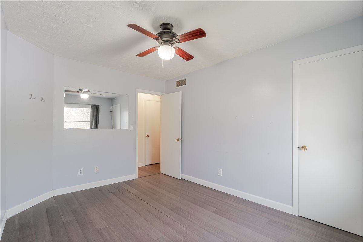 103 South Towanda Avenue, Unit 3 Normal, IL 61761 - Photo 10 of 17 an empty room with wooden floor and ceiling fan