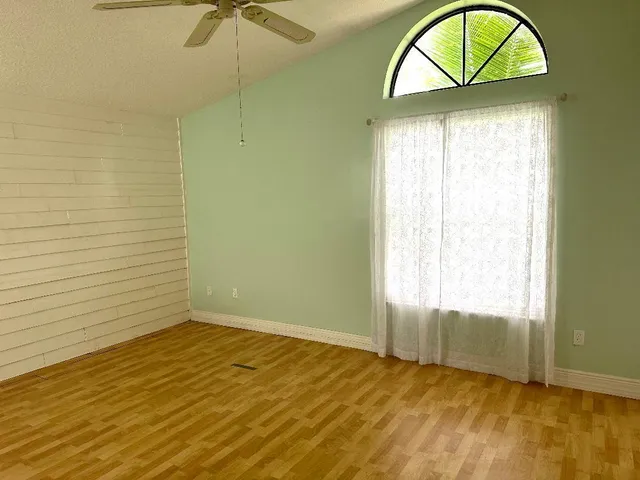 a view of room with window and wooden floor