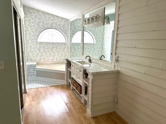 a bathroom with a sink a vanity and a mirror