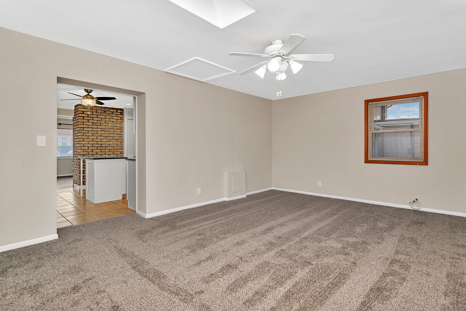 4239 Custer Avenue Lyons, IL 60534 - Photo 12 of 27 a view of an empty room with wooden floor and a ceiling fan