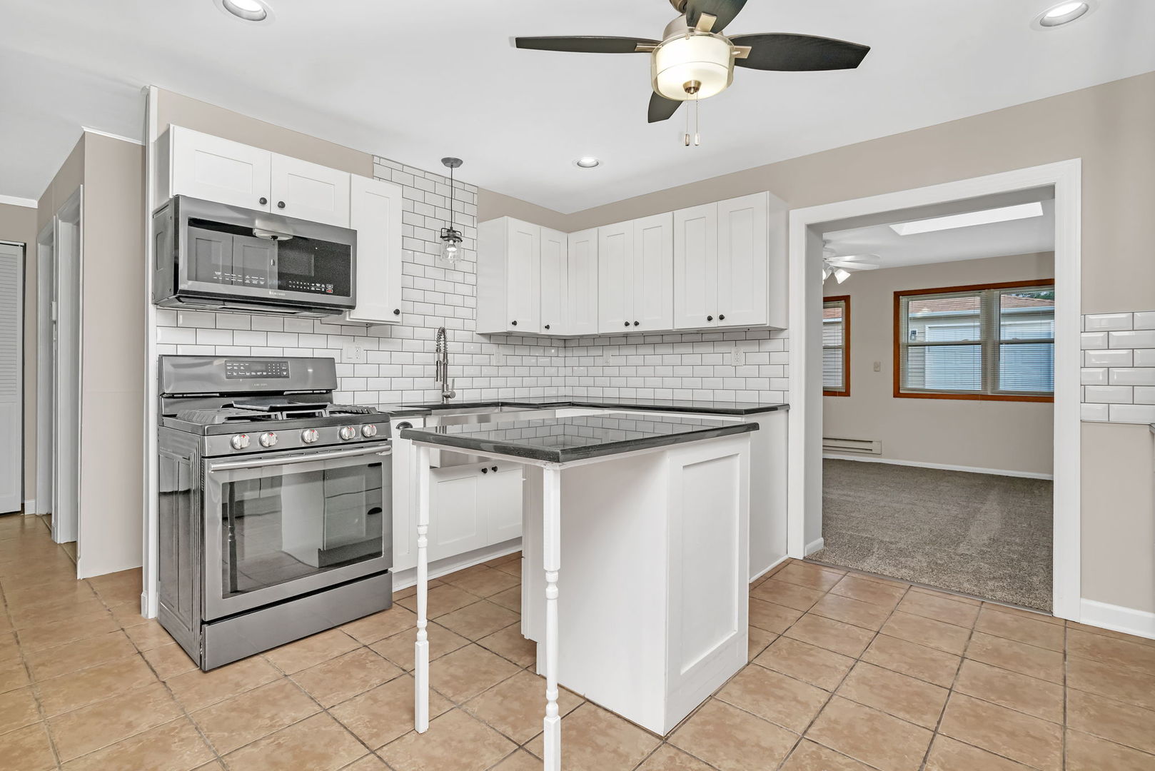 4239 Custer Avenue Lyons, IL 60534 - Photo 8 of 27 a kitchen with stainless steel appliances granite countertop a stove microwave and a refrigerator