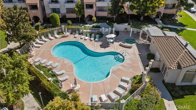 an aerial view of a house with swimming pool and outdoor seating