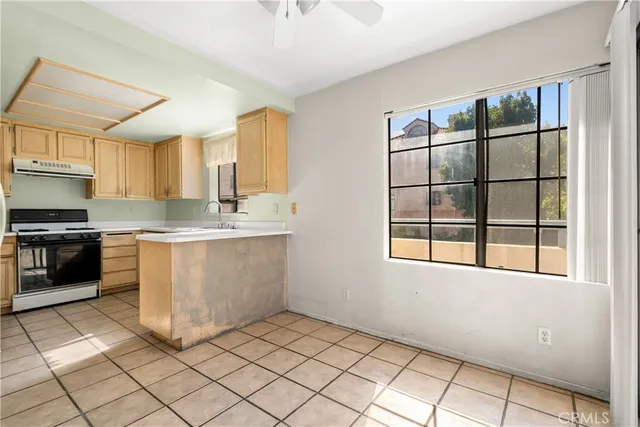 a kitchen with a cabinets a sink and a stove top oven