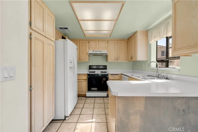 a kitchen with a refrigerator and a sink