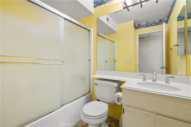 a bathroom with a toilet a sink and a mirror