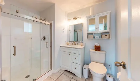a bathroom with a toilet a sink and shower