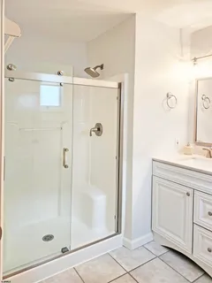 a bathroom with a shower sink and mirror