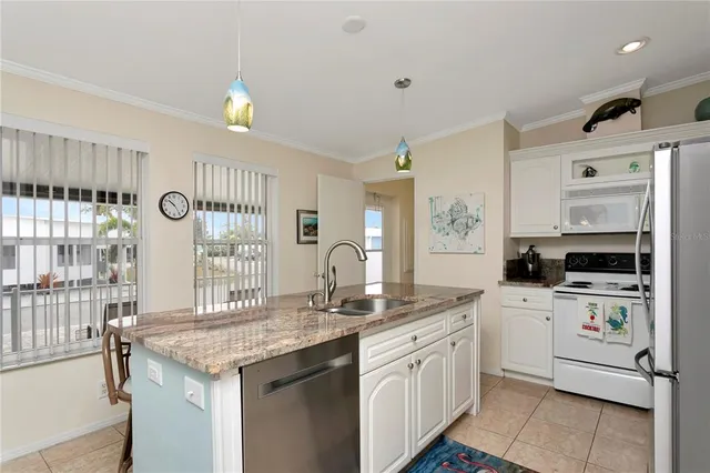 a kitchen with a sink stove and cabinets