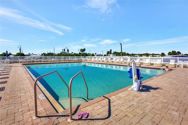 a view of a swimming pool with lounge chairs