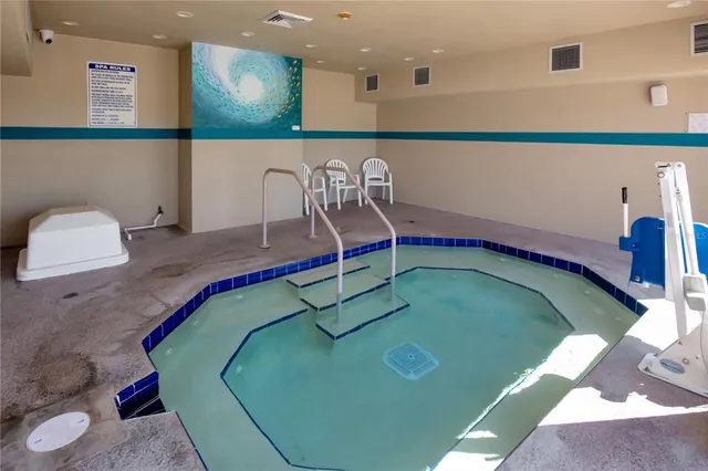 a room with a table tennis air hockey table and arcade game machine