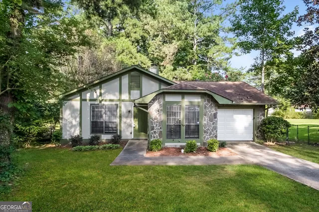 a front view of a house with a yard and porch